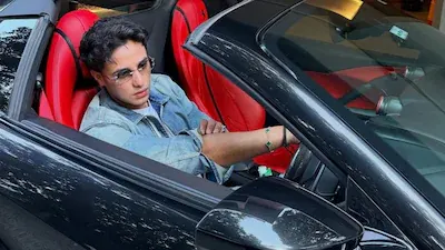 Abhishek Sharma seated inside a luxury convertible, representing his car collection and lifestyle in 2026.