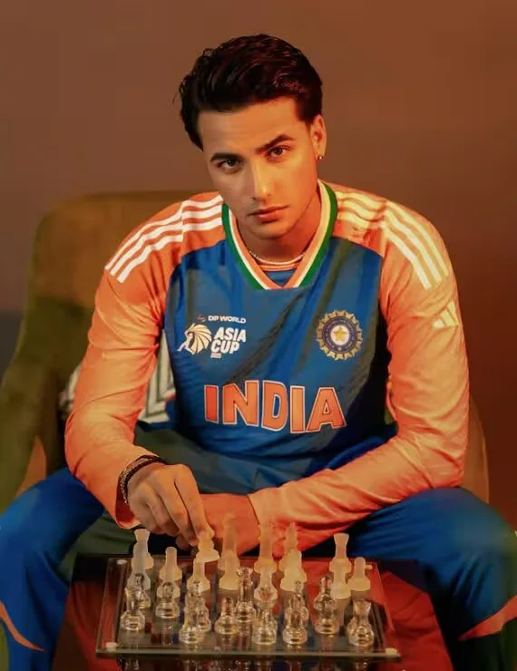 Abhishek Sharma wearing the India cricket jersey beside a chessboard for his 2026 net worth and career profile.