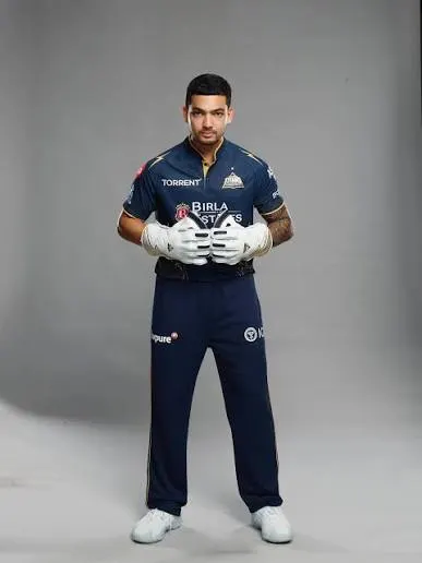 Anuj Rawat in Gujarat Titans cricket kit, representing the latest chapter of his IPL career after spells with Rajasthan Royals and Royal Challengers Bengaluru.
