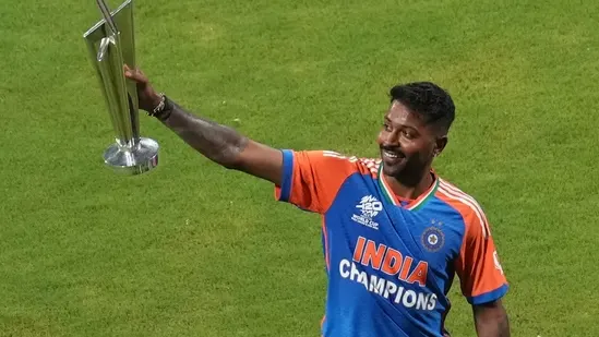 Hardik Pandya lifting a championship trophy while wearing India’s T20 World Cup winners jersey.