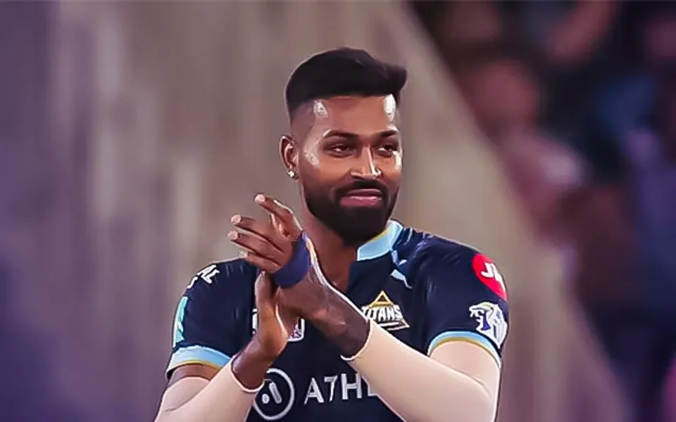 Hardik Pandya applauding in the Gujarat Titans jersey during an IPL match.