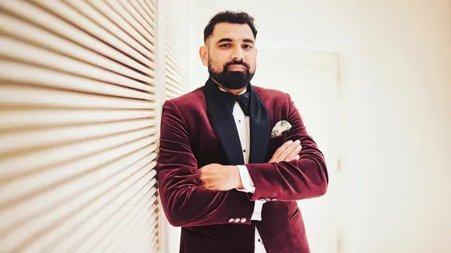 Indian cricketer in a formal burgundy suit, representing Mohammed Shami brand endorsements, lifestyle and off-field income sources.
