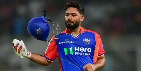 Rishabh Pant holding his helmet after batting for Delhi Capitals during an IPL match.