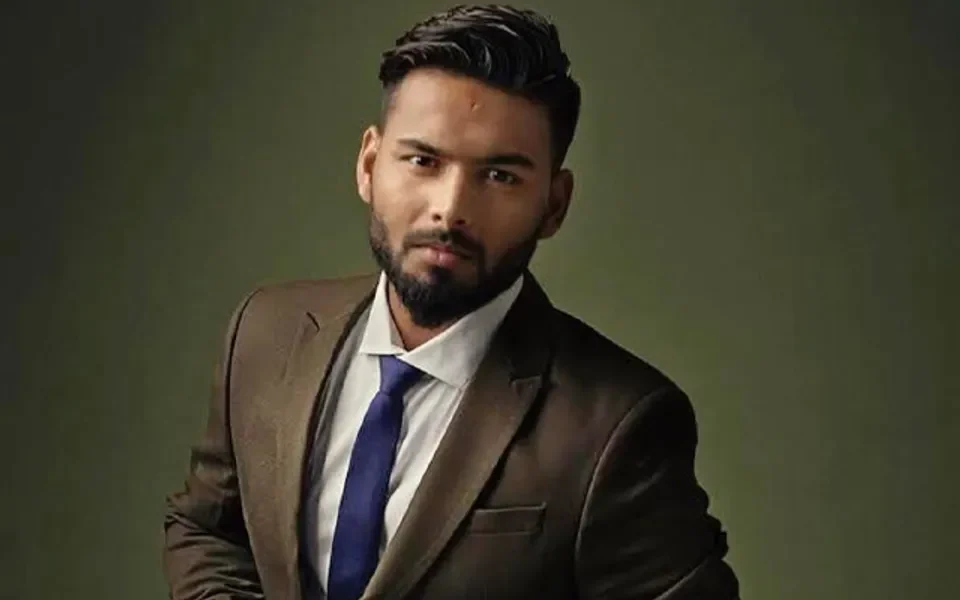 Rishabh Pant wearing a formal suit in a portrait representing his investments and business ventures.