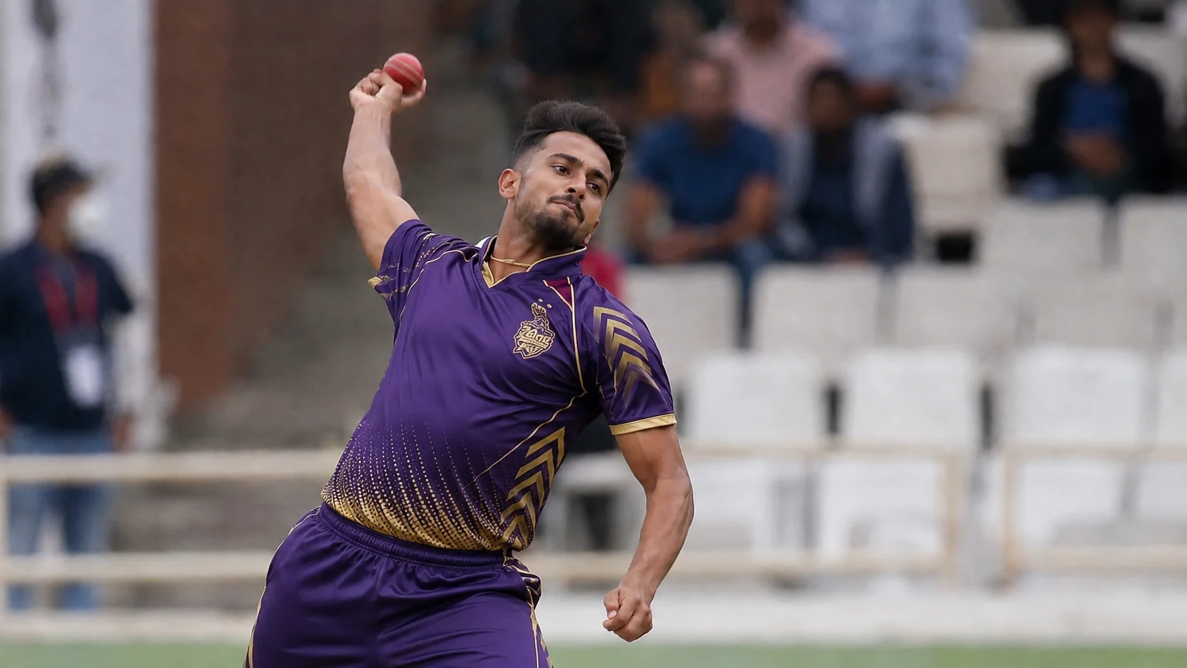 Umran Malik bowling in a purple Kolkata Knight Riders-style kit during a franchise cricket match.