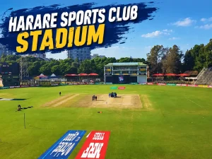 Harare Sports Club Stadium in Harare, Zimbabwe, showing the cricket pitch, green outfield, stands and pavilion under a clear blue sky.