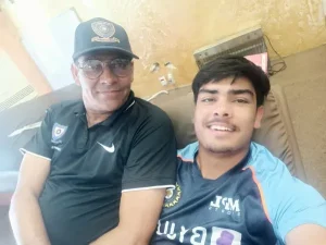 Young Indian cricketer taking a selfie with his father and longtime coach, highlighting the family support behind his cricket journey.