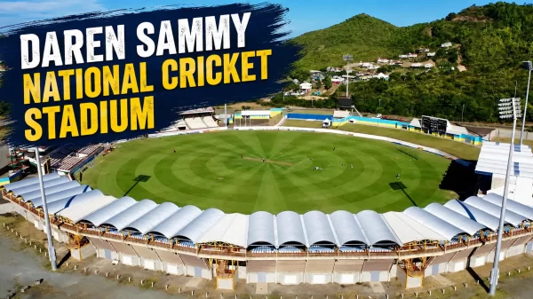 Aerial view of Daren Sammy National Cricket Stadium in Gros Islet, Saint Lucia, showing the cricket field, stands, floodlights, and surrounding green hills.