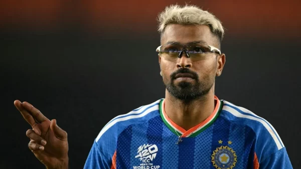 Hardik Pandya representing India in the T20 World Cup jersey while gesturing on the field.