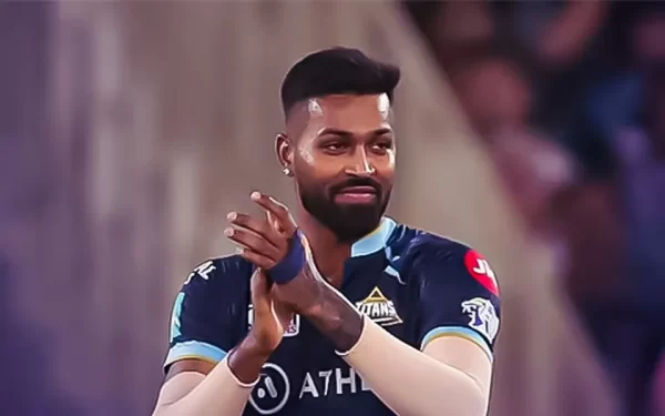 Hardik Pandya applauding in the Gujarat Titans jersey during an IPL match.