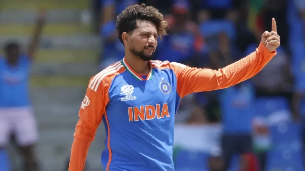 Indian cricketer in India jersey celebrating on the field, illustrating Kuldeep Yadav’s Grade B BCCI contract and tournament bonus earnings.
