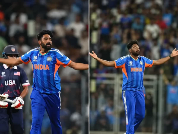 Indian fast bowler celebrating with arms spread while wearing India’s blue T20 cricket jersey during a stadium match.