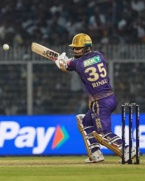 Rinku Singh batting for Kolkata Knight Riders in a purple jersey displaying his number 35.