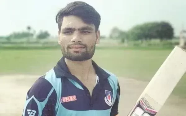 Young Rinku Singh holding a cricket bat on a local ground during his early cricket years in Aligarh.