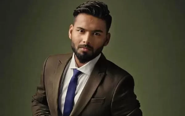 Rishabh Pant wearing a formal suit in a portrait representing his investments and business ventures.
