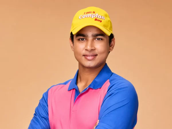 Young cricketer wearing a yellow “I am a Complan Boy” cap and pink-and-blue cricket shirt, illustrating the endorsement section of a Vaibhav Suryavanshi net worth 2026 article.